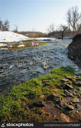 The spring river. A rough stream after a spring thawing weather