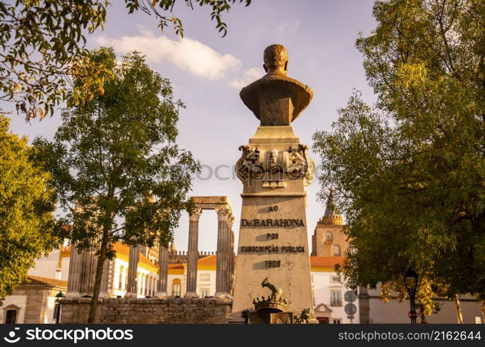 the Statue and Monument of Dr. Barahona on the Largo do Conde de Vila Flor in the old Town of the city Evora in Alentejo in Portugal. Portugal, Evora, October, 2021