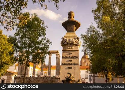 the Statue and Monument of Dr. Barahona on the Largo do Conde de Vila Flor in the old Town of the city Evora in Alentejo in Portugal. Portugal, Evora, October, 2021