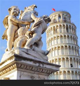 The statue of angels on Square of Miracles in Pisa and Leaning Tower, Italy