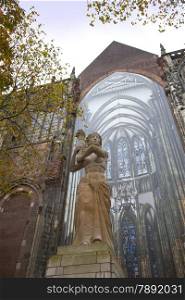 The statue of Corinne Franz?n-Heslenfeld in the direction of the Dom of Utrecht, Netherlands