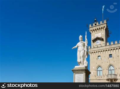 The Statue of liberty and the town hall of the City of San Marino with large space for your own text over clear blue sky