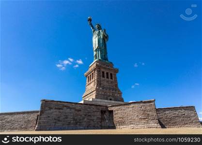 The Statue of Liberty under the blue sky background, Lower Manhattan, New York City, Architecture and building with tourist concept