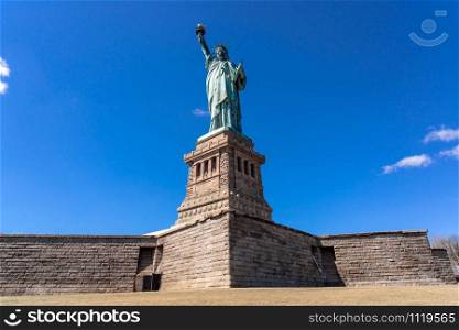 The Statue of Liberty under the blue sky background, Lower Manhattan, New York City, Architecture and building with tourist concept