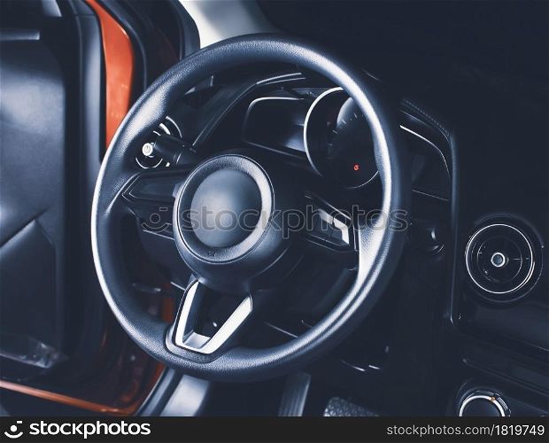 The steering wheel in the car driver cockpit of modern car
