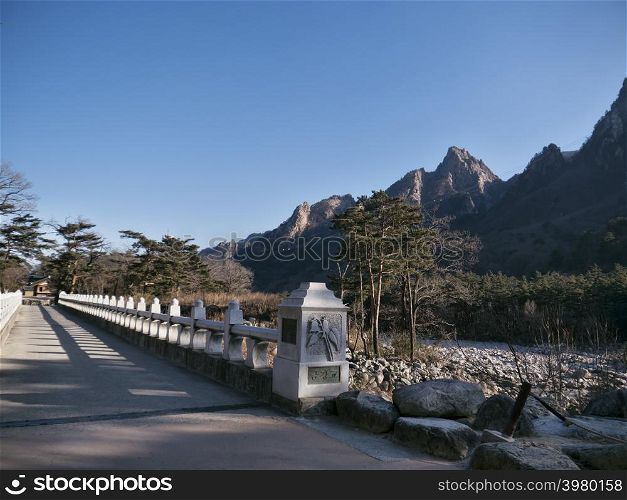 The stone bridge and beautiful mountains on the background in Seoraksan National Park, South Korea