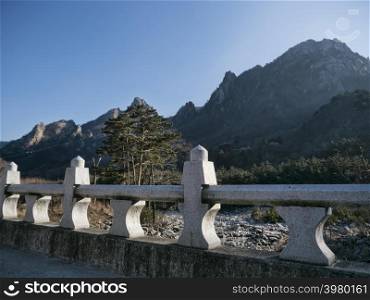 The stone bridge and beautiful mountains on the background in Seoraksan National Park, South Korea