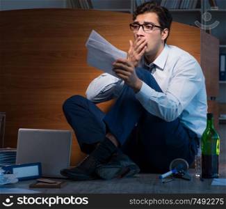 The stressed businessman working overtime in depression. Stressed businessman working overtime in depression