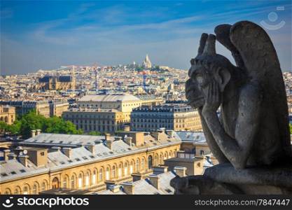 The Stryge (most famous of the Chimeres) looking toward Basilica of the Sacred Heart of Jesus at Notre Dame Cathedral in Paris