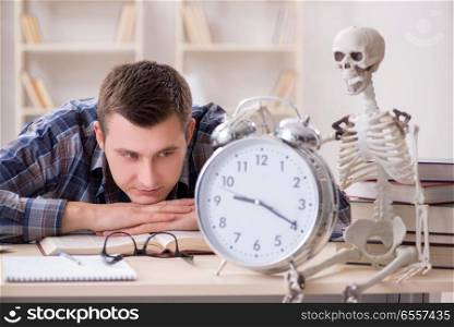 The student and skeleton preparing for school exams. Student and skeleton preparing for school exams