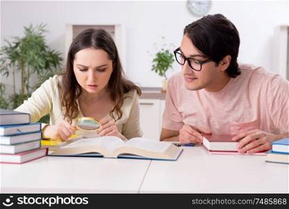 The students preparing for exam together at home . Students preparing for exam together at home