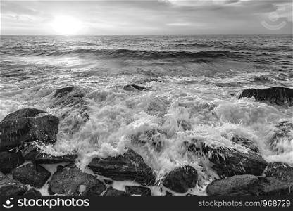 The stunning black and white seascape with the sky and water foam at the rocky coastline of the Black Sea