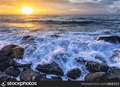 The stunning seascape with the colorful sunrise sky at the rocky coastline of the Black Sea