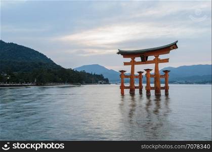 The stunning sunset view of famous floating torii gate of the Itsukushima Shrine in Miyajima, Hiroshima, Japan
