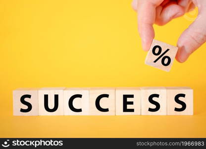 The success of the text on a yellow background of wooden cubes. business growth in teamwork.. The success of the text on a yellow background of wooden cubes.