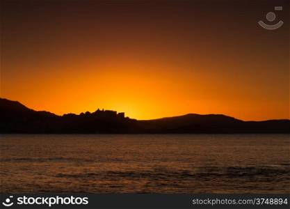 The sun is setting behind the citadel of Calvi in the Balagne region of Corsica