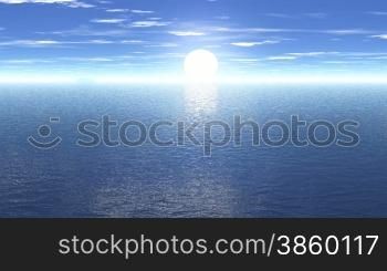 The sun rises rapidly above the sea horizon. The camera moves towards the coast and shows the sun&acute;s reflection in the lake.
