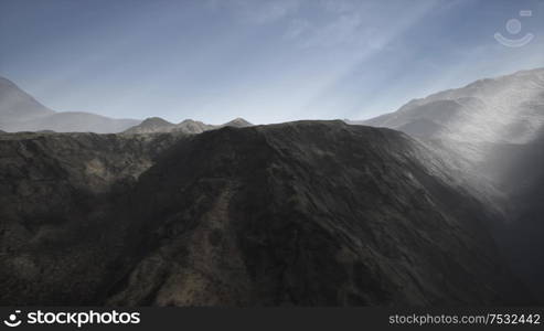 the sun&rsquo;s rays against the backdrop of the mountains and the lava-rocky wet shore in the foreground. Sun Rays against the Backdrop of the Mountains