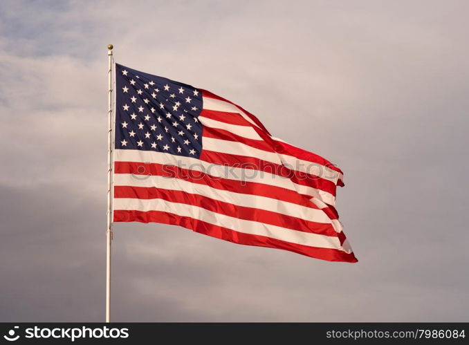 The sun sets and makes this flag glow on the way down