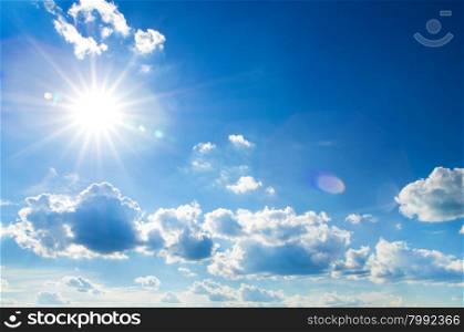 The sun shines bright in the daytime in summer. Blue sky and clouds.