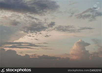 The sun shines through the clouds in the sunset sky with dramatic light. The shape of the clouds evokes imagination and creativity. They can be used as wallpapers that look amazing. Selective focus.