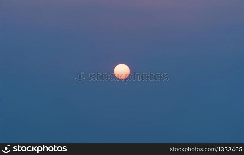 The sun with sunset sky. Abstract nature background. Dramatic blue and orange, colorful clouds at twilight time.