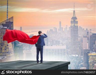 The super hero businessman on top of building ready for challenge. Super hero businessman on top of building ready for challenge