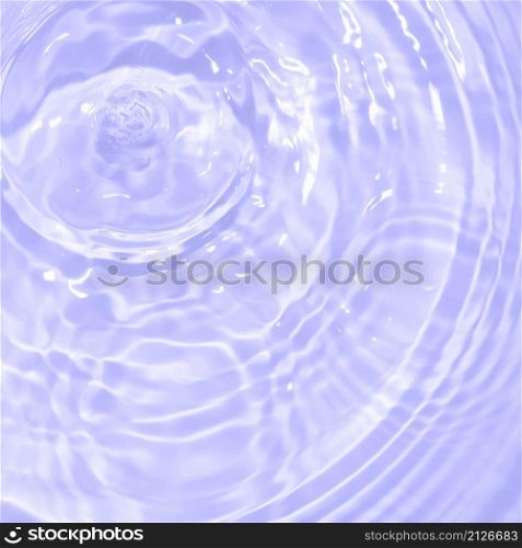 The surface of light on the purple transparent swimming pool water. Abstract wavy background. Water waves in sunlight banner. Square Trendy banner with 2022 color of the year very peri.. The surface of light on the purple transparent swimming pool water. Abstract wavy background. Water waves in sunlight banner. Square Trendy banner with 2022 color of the year very peri