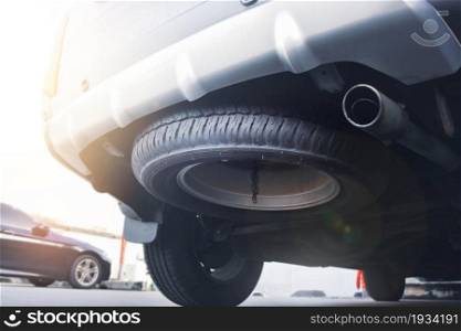 The SUV car spare wheel is hidden beneath the vehicle (Sport Utility Vehicle)