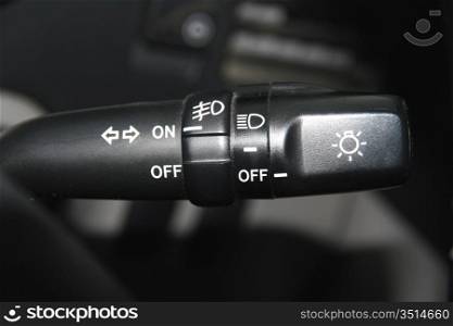 The switch of turn and light of headlights of the car on a wheel