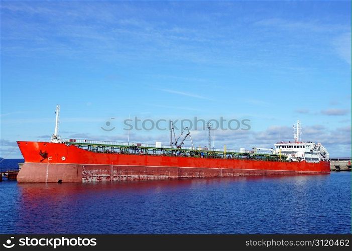 The tanker is moored in the port and loaded fuel