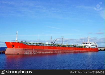The tanker is moored in the port and loaded fuel