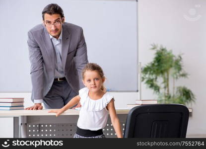 The teacher with young girl in the classroom. Teacher with young girl in the classroom