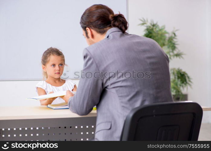 The teacher with young girl in the classroom. Teacher with young girl in the classroom