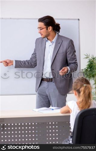 The teacher with young girl in the classroom. Teacher with young girl in the classroom