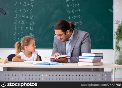 The teacher with young girl in the classroom. Teacher with young girl in the classroom