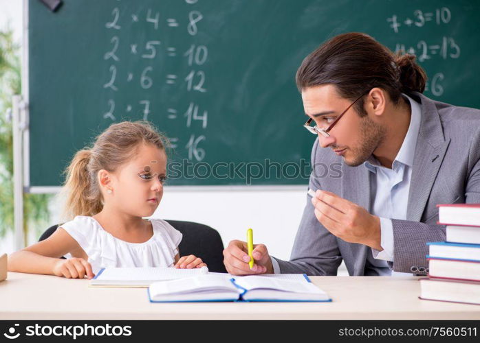 The teacher with young girl in the classroom. Teacher with young girl in the classroom