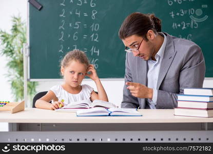 The teacher with young girl in the classroom. Teacher with young girl in the classroom