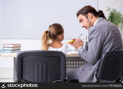 The teacher with young girl in the classroom. Teacher with young girl in the classroom