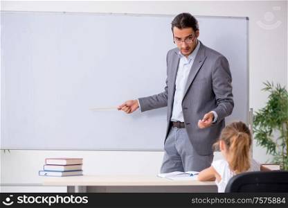 The teacher with young girl in the classroom. Teacher with young girl in the classroom