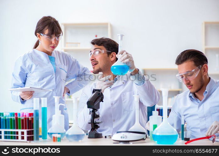 The team of chemists working in the lab. Team of chemists working in the lab