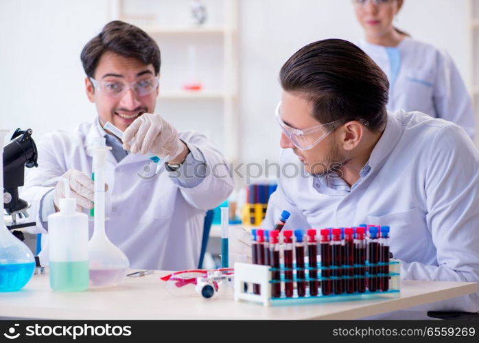 The team of chemists working in the lab. Team of chemists working in the lab