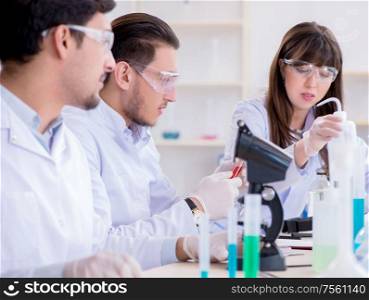 The team of chemists working in the lab. Team of chemists working in the lab