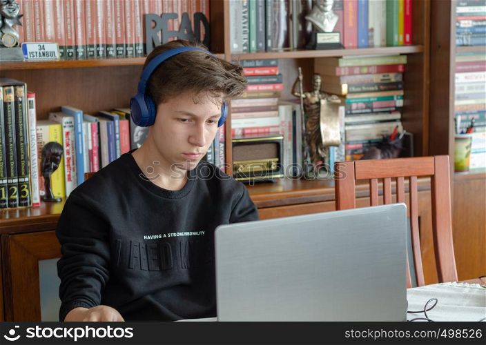 The teenage is listening to music at home