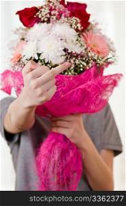 The teenager with a bunch of flowers shows indecent gesture