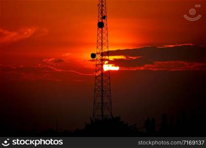the telecommunication station pole with the beautiful sun set or sun rise time background.