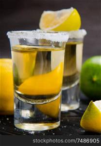 The tequila drink served in glasses with lime and salt. Tequila drink served in glasses with lime and salt