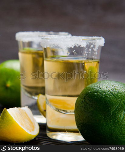 The tequila drink served in glasses with lime and salt. Tequila drink served in glasses with lime and salt