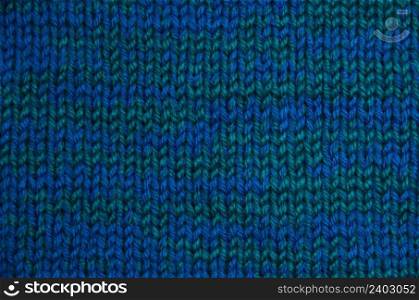 The texture of a knitted woolen fabric blue.