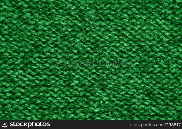The texture of a knitted woolen fabric green.